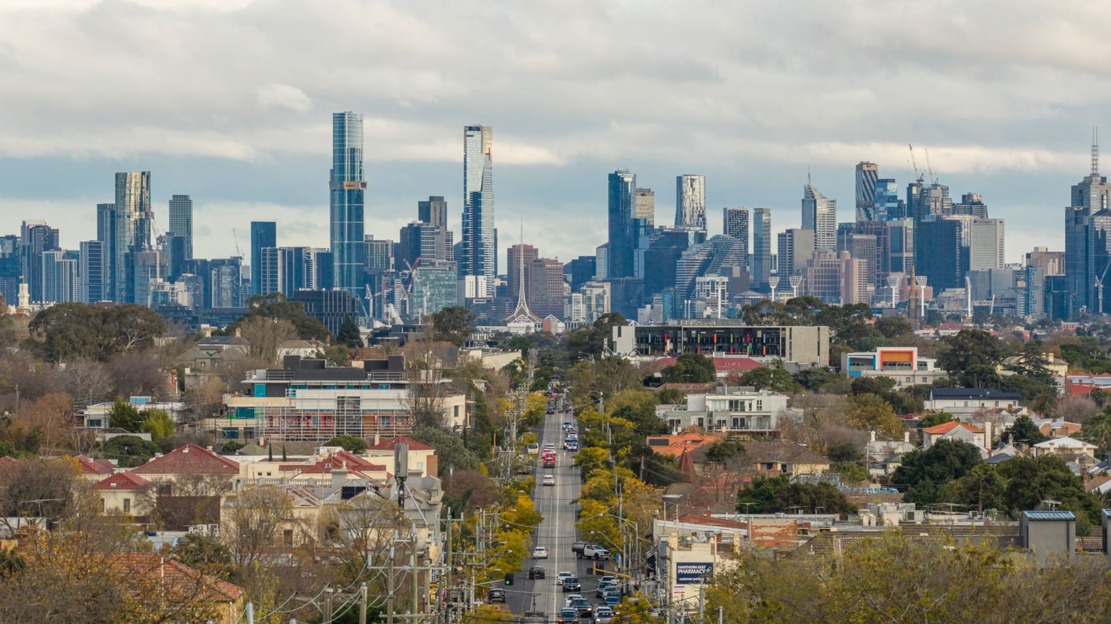 A cinematic panoramic view of the Melbourne city skyline during golden hour.